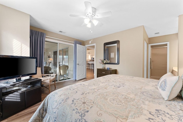 bedroom with hardwood / wood-style floors, access to outside, and ceiling fan