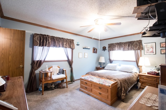 carpeted bedroom featuring ceiling fan, ornamental molding, and a textured ceiling