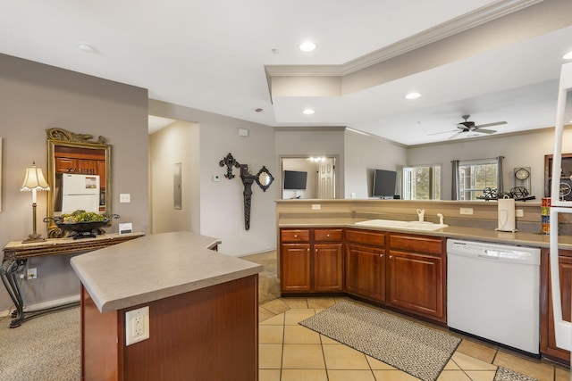 kitchen featuring a kitchen island, sink, electric panel, crown molding, and white appliances