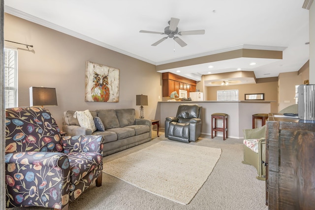 carpeted living room featuring ceiling fan and ornamental molding