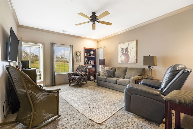 living room with ornamental molding, carpet floors, and ceiling fan