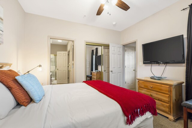 carpeted bedroom with connected bathroom, a closet, and ceiling fan