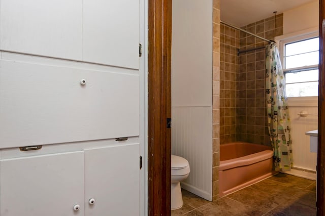 bathroom featuring shower / bath combination with curtain and toilet