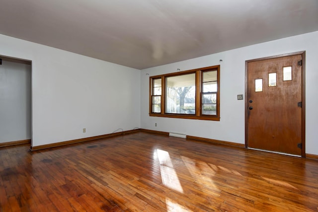 foyer entrance with wood-type flooring and a baseboard radiator