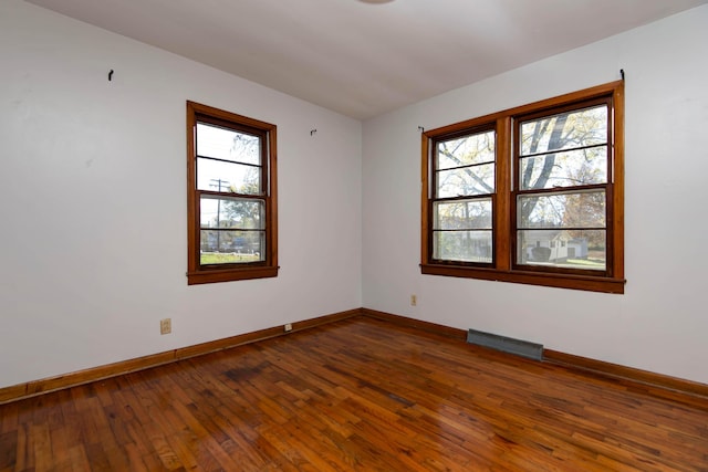 spare room with dark hardwood / wood-style flooring