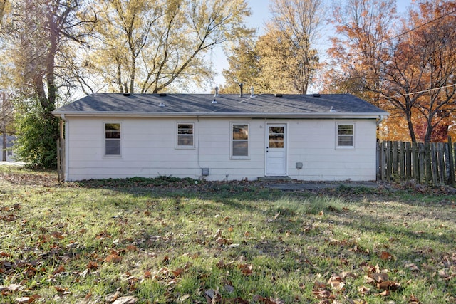 rear view of property with a yard