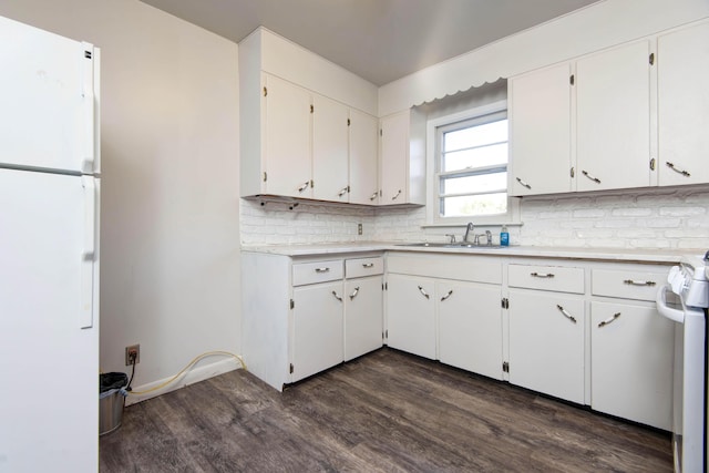 kitchen with white cabinetry, white fridge, sink, and dark wood-type flooring