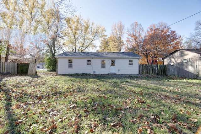 back of house with a lawn