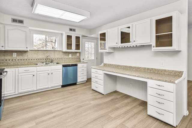 kitchen with sink, light hardwood / wood-style flooring, white cabinetry, built in desk, and stainless steel dishwasher