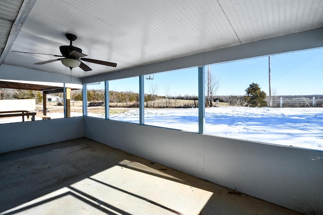 unfurnished sunroom featuring plenty of natural light and ceiling fan