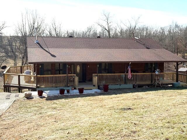 view of front of house with a deck and a front lawn