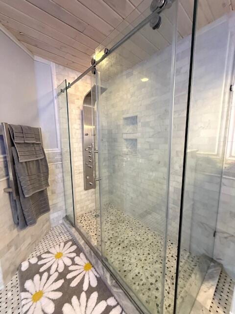 bathroom featuring wood ceiling and walk in shower