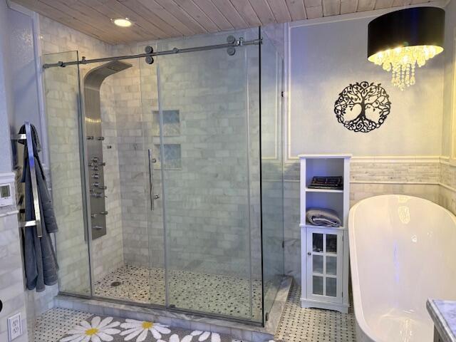 bathroom with tile patterned floors, separate shower and tub, and wooden ceiling