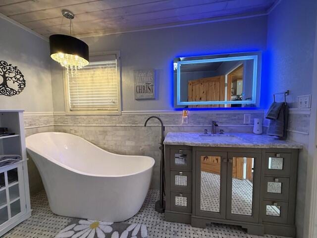 bathroom featuring wood ceiling, tile walls, an inviting chandelier, vanity, and a tub to relax in