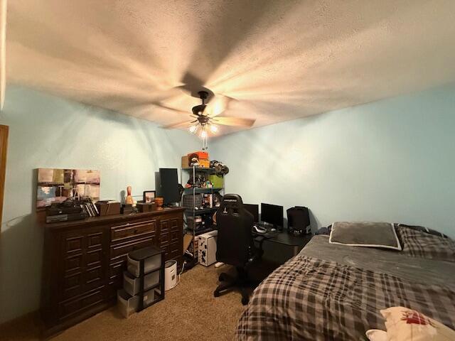 bedroom with carpet and a textured ceiling