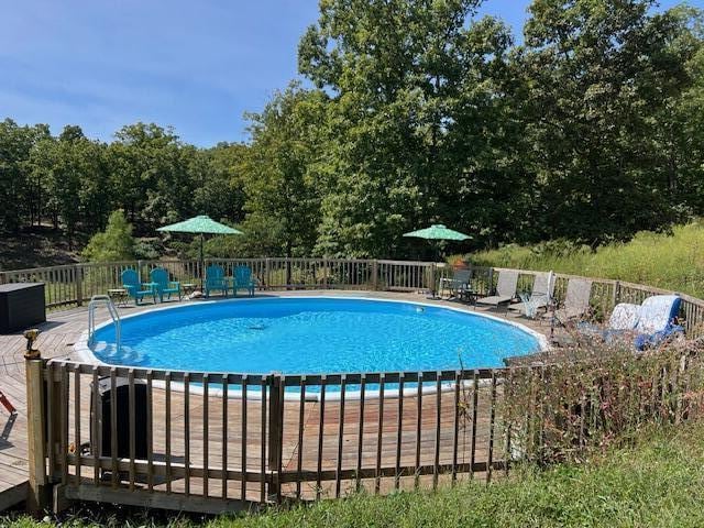 view of swimming pool featuring a wooden deck