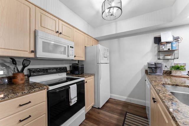 kitchen with white appliances, dark wood-type flooring, dark stone counters, a chandelier, and light brown cabinets