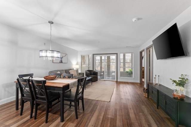 dining room featuring an inviting chandelier and dark hardwood / wood-style floors