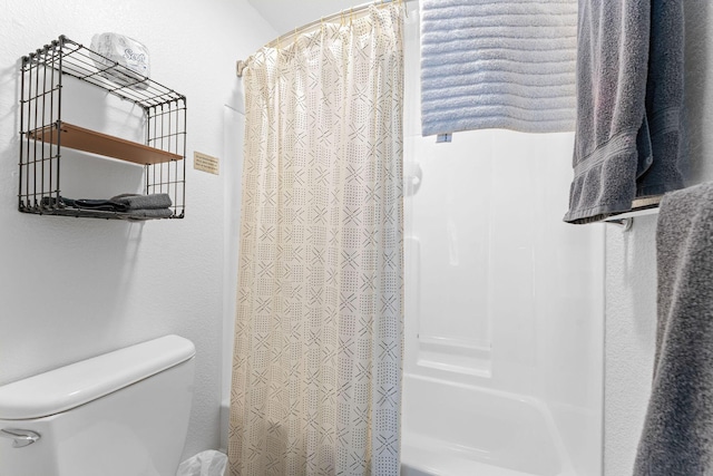 bathroom with toilet and shower / bath combo with shower curtain