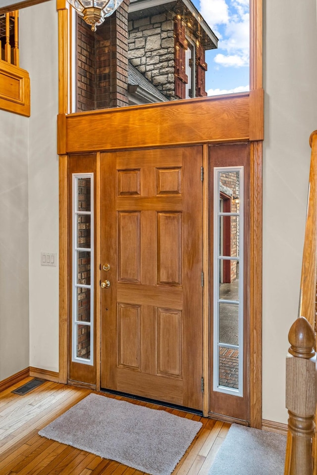 entrance foyer featuring a high ceiling and light wood-type flooring