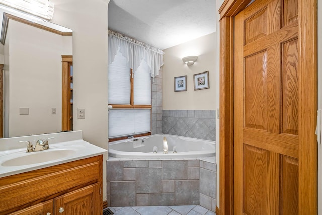 bathroom with vanity, tiled tub, and tile patterned floors