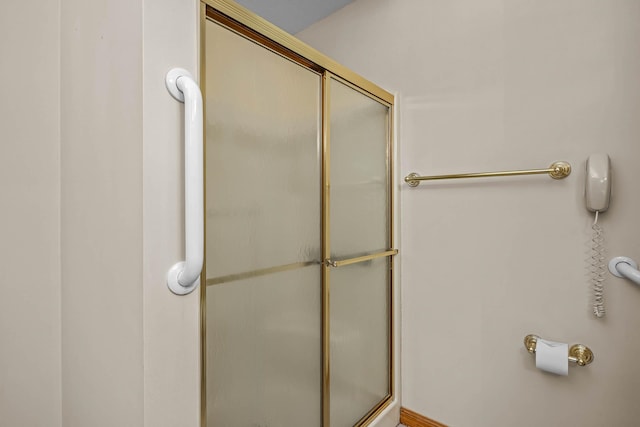 bathroom with a shower with shower door