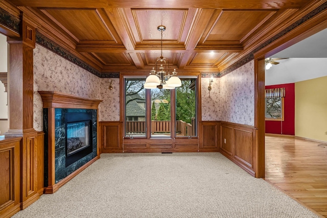 unfurnished living room featuring a fireplace, ornamental molding, coffered ceiling, light carpet, and wooden ceiling