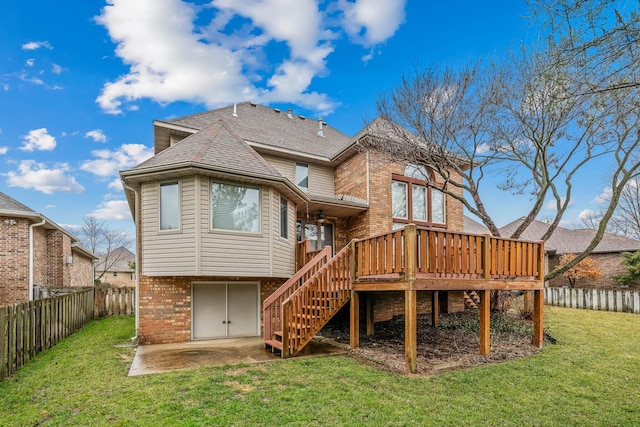 back of house with a lawn, a patio, and a deck