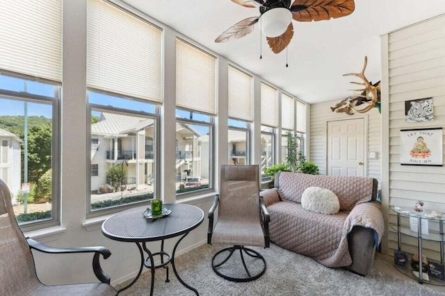 sunroom / solarium featuring ceiling fan