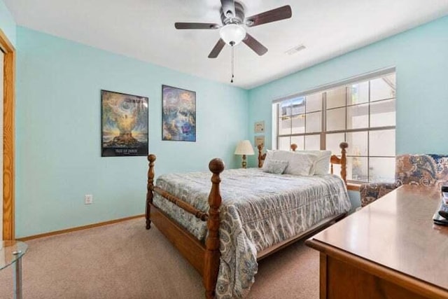 bedroom with ceiling fan and light carpet