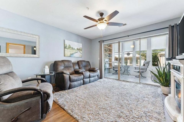 living room featuring hardwood / wood-style flooring and ceiling fan