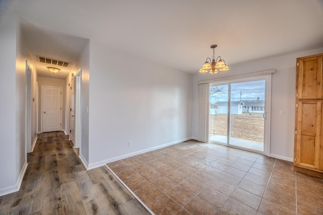 unfurnished dining area featuring an inviting chandelier