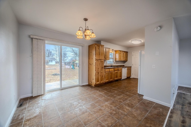 kitchen with pendant lighting, sink, a notable chandelier, and dishwasher