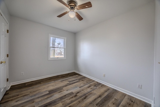 spare room with dark hardwood / wood-style floors and ceiling fan