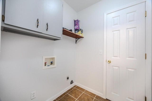 clothes washing area featuring dark tile patterned flooring, hookup for a washing machine, cabinets, and hookup for an electric dryer