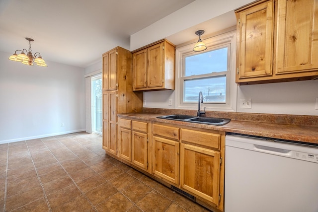 kitchen featuring hanging light fixtures, dishwasher, sink, and a chandelier