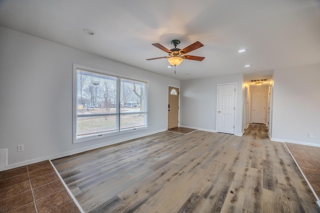 interior space with ceiling fan and wood-type flooring