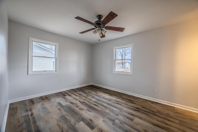 empty room with dark hardwood / wood-style flooring and ceiling fan