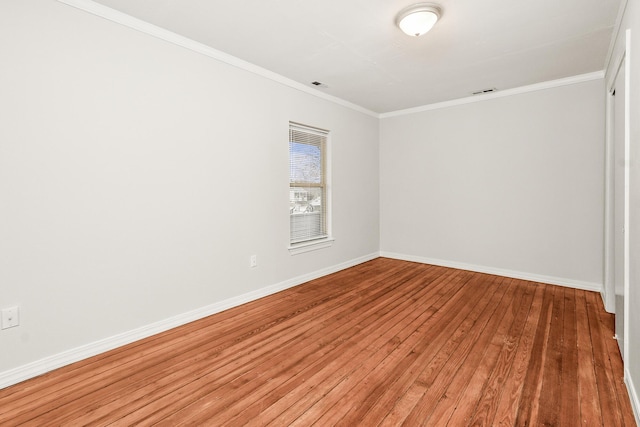 spare room with hardwood / wood-style floors and ornamental molding