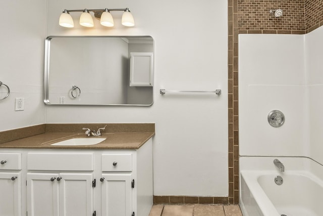 bathroom featuring vanity, tile patterned floors, and tiled shower / bath