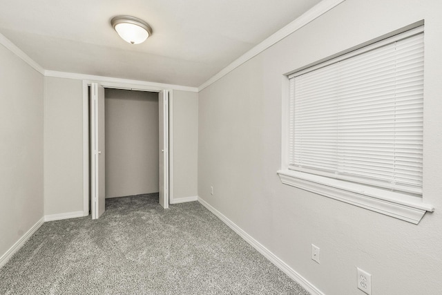 unfurnished bedroom featuring crown molding, a closet, and light carpet