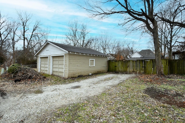 exterior space featuring a garage and an outbuilding