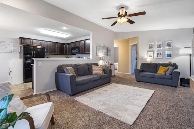 carpeted living room with ceiling fan and lofted ceiling