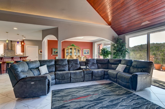 living room with vaulted ceiling, crown molding, and wood ceiling