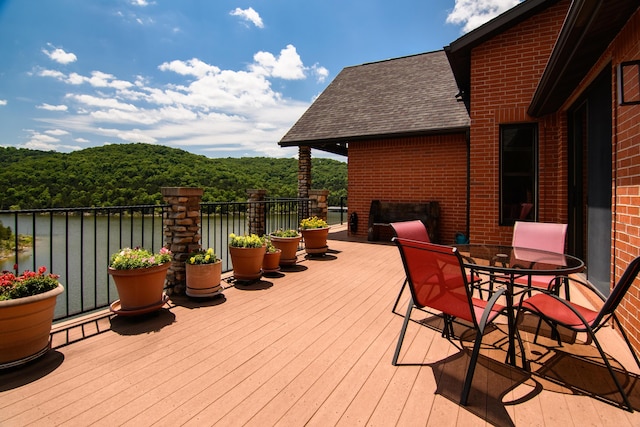 wooden terrace featuring a water view