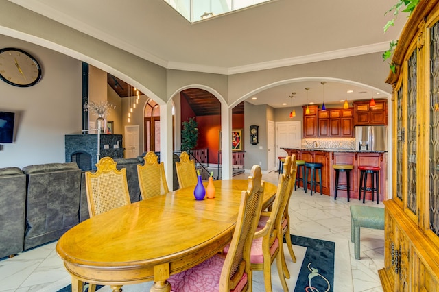 dining space with crown molding