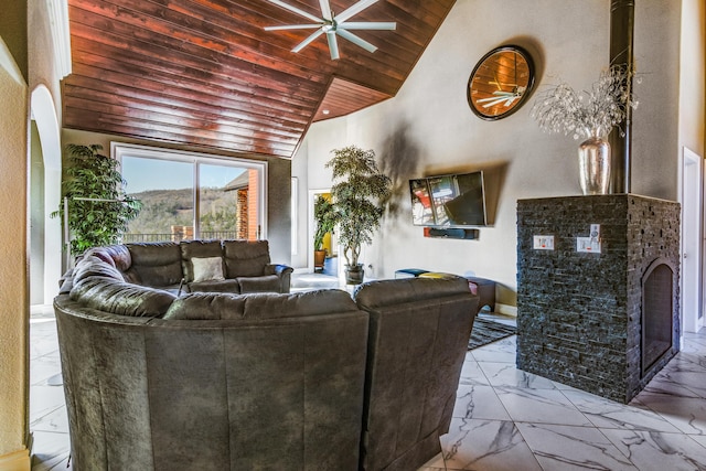 living room with lofted ceiling, a fireplace, wooden ceiling, and ceiling fan