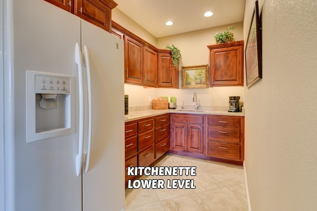 kitchen with white fridge with ice dispenser and sink