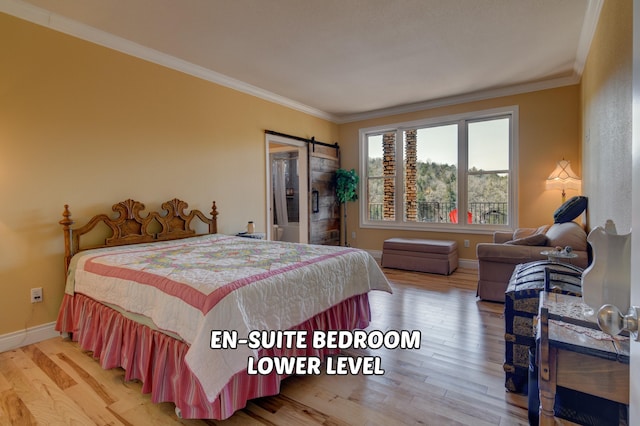 bedroom featuring hardwood / wood-style flooring, ornamental molding, and a barn door