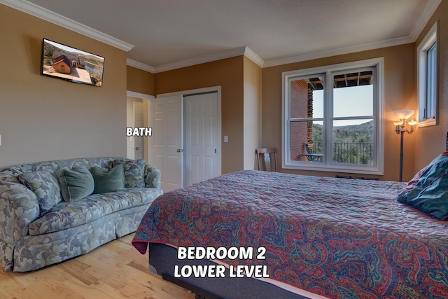 bedroom featuring ornamental molding, hardwood / wood-style floors, and a closet